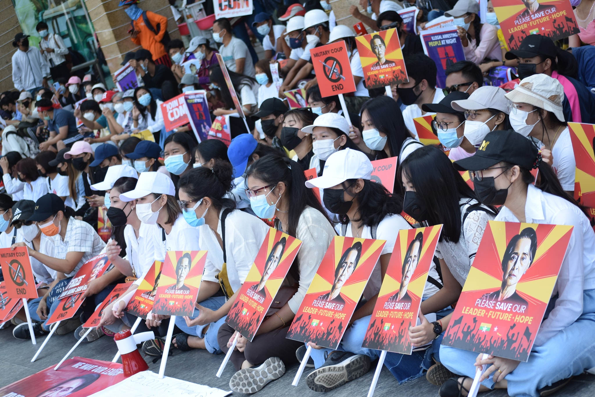 Crowd holding signs for Aung San Suu Kyi